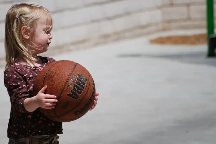 toddler playing with basketball