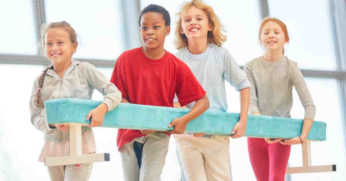 kids holding balance beam