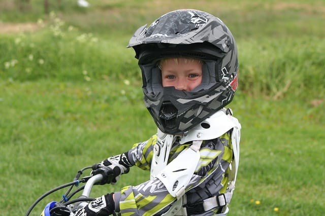 kid riding atv with helmet