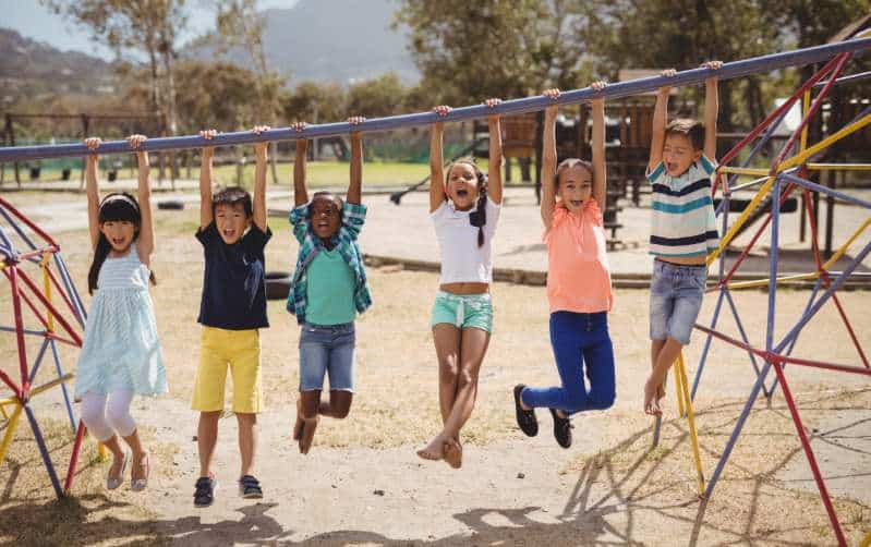 kids swinging on monkey bar